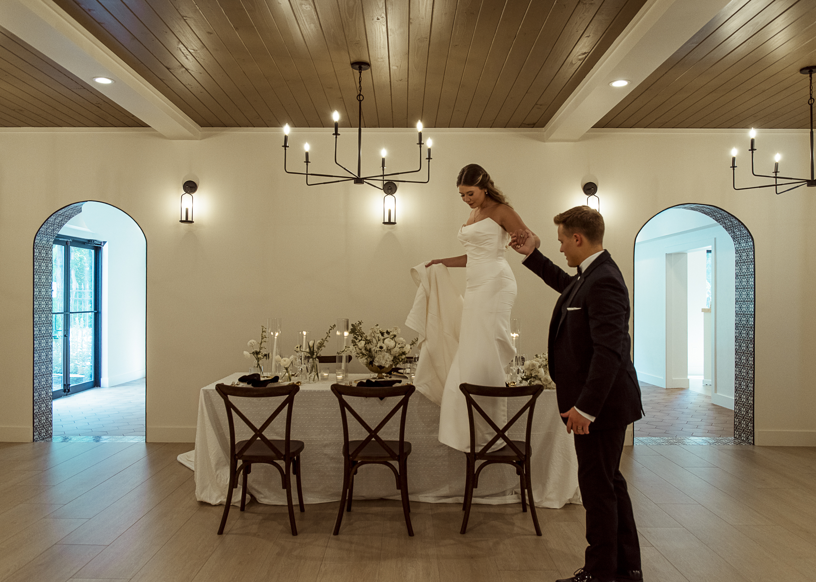 Editorial wedding photo of couple walking across chairs at the Spanish Quarter in Jacksonville, Florida.