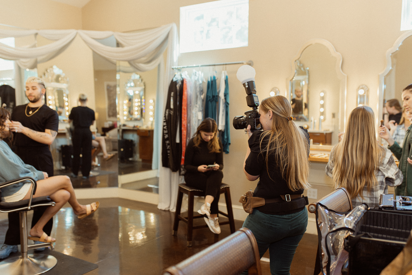 Behind the scenes of wedding photographer photographing bride getting ready.